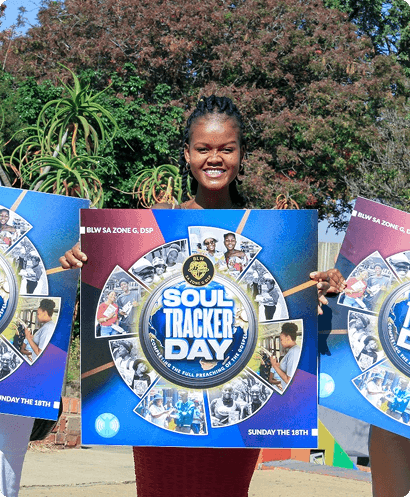 Picture of a man on his knees on the floor praying in a crowd of people